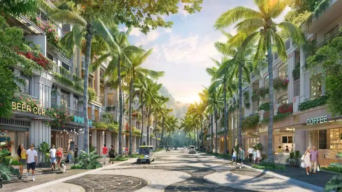 Modern tropical cityscape with lush palm trees, vibrant storefronts, and outdoor cafes at Blanca City by Sun Group. A lively urban area blending nature and contemporary living.